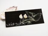 12mm mussel shell shaped flameworked glass earring studs, in ivory displayed on an earring card.