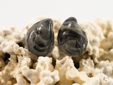 Detailed flameworked glass earring studs shaped like mini mussel shells are inspired by the colour of black sea salt in swirls of greys and charcoal.