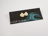 Shell shaped flameworked glass in a pale yellow ivory colour displayed on an earring card.