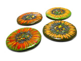four glass coasters with images of sunflowers on alternating light and dark green background. image is on a white background.